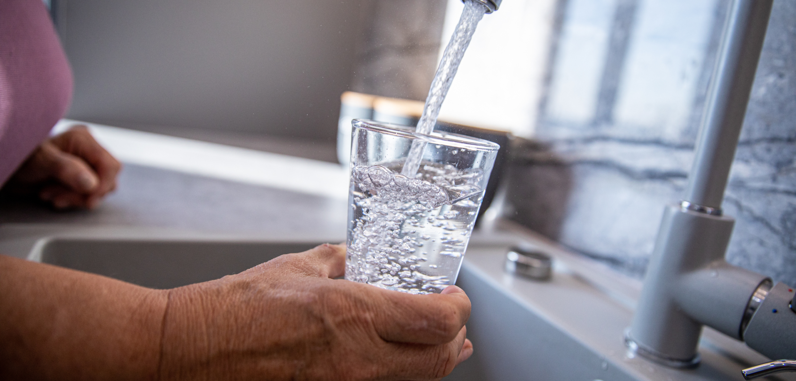 filling glass water from sink