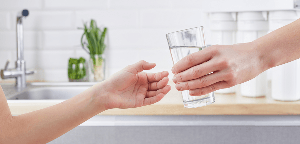 handing over a full glass clean water